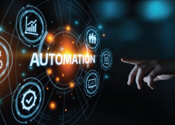 A visual metaphor for technological automation, displaying glowing icons and the word "AUTOMATION" being interacted with by a human hand.