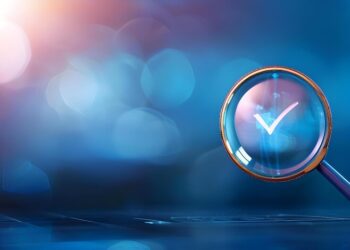 A concept of review or audit, depicted by a magnifying glass over a green checkmark, surrounded by a luminous, abstract backdrop.