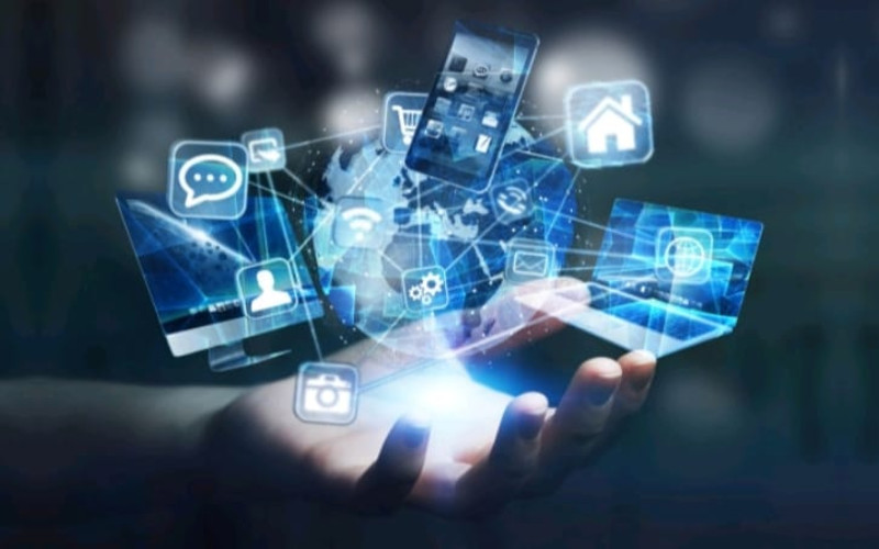 A conceptual image of cloud computing or the Internet of Things, with digital screens and icons orbiting a central globe above an open hand.