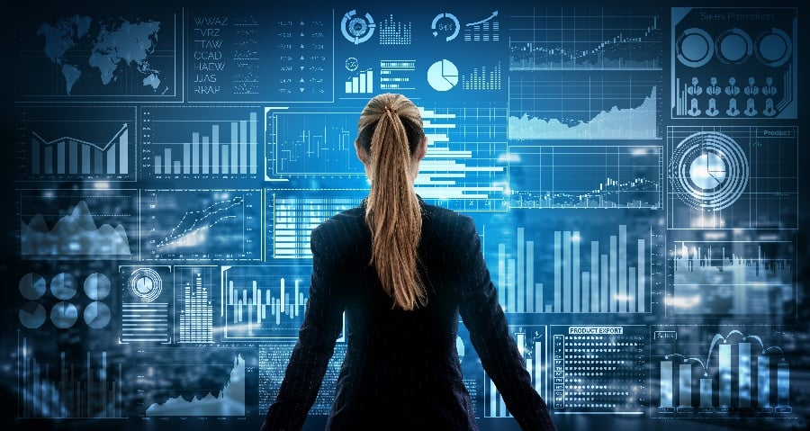 A person observing a complex, interactive digital dashboard filled with business intelligence metrics and data analytics, symbolizing strategic oversight or data-driven decision making.