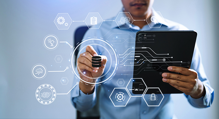 A hand interacting with a holographic display of digital marketing tools and business icons over a tablet.